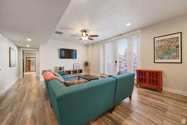 13862 S 7300 W, Herriman, UT 84096 - living room featuring wood finished floors, french doors, a ceiling fan, a textured ceiling, and recessed lighting