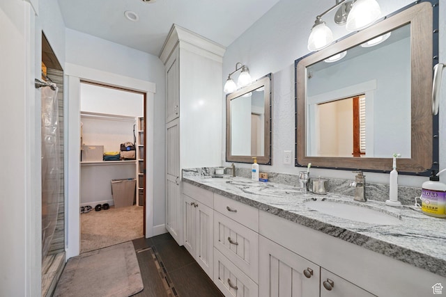 13862 S 7300 W, Herriman, UT 84096 - bathroom featuring double vanity, a shower, a spacious closet, and tile patterned floors