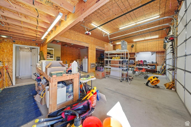 13862 S 7300 W, Herriman, UT 84096 - garage with a garage door opener, a workshop area, and freestanding refrigerator