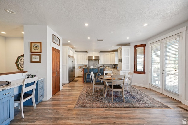 13862 S 7300 W, Herriman, UT 84096 - dining space featuring wood finished floors, recessed lighting, a textured ceiling, and french doors