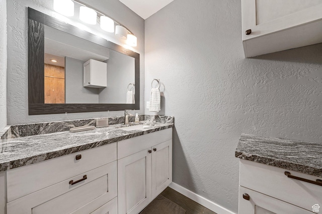 13862 S 7300 W, Herriman, UT 84096 - bathroom with vanity, wood finished floors, and a textured wall