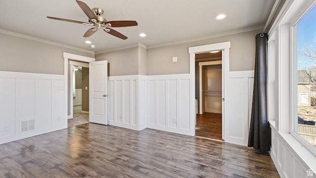 spare room featuring wood finished floors, recessed lighting, visible vents, a ceiling fan, and wainscoting