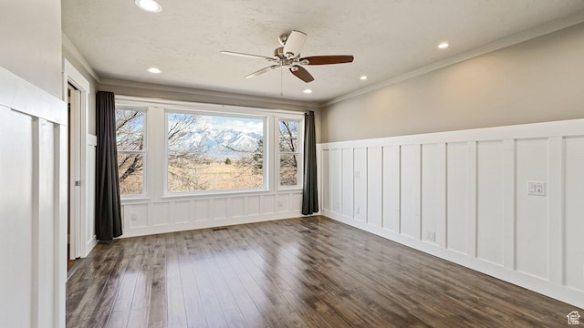 unfurnished room featuring ceiling fan, recessed lighting, a decorative wall, and dark wood-type flooring