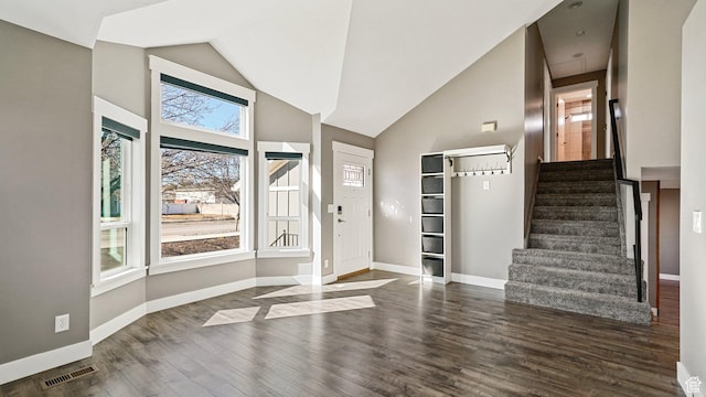 entryway featuring wood finished floors, baseboards, stairs, and visible vents