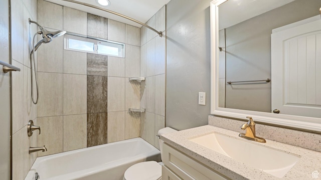 bathroom with shower / bathing tub combination, toilet, and vanity