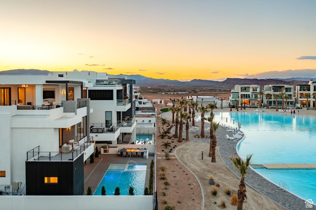 864 W Sapphire Sky Ln Unit 546, St George, UT 84790 - pool at dusk featuring a mountain view and a community pool