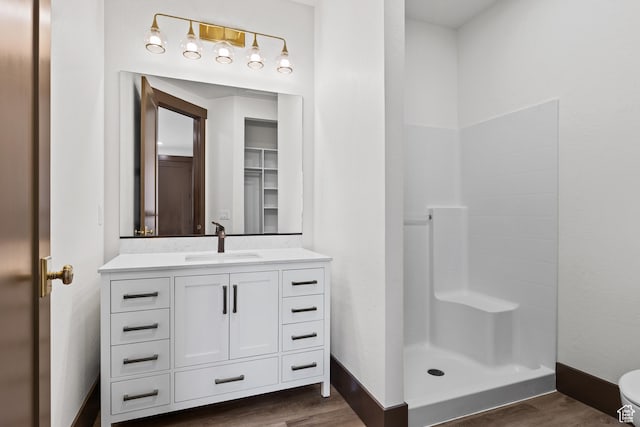 810 E 150 S, Enterprise, UT 84725 - full bathroom with wood finished floors, vanity, a stall shower, and baseboards