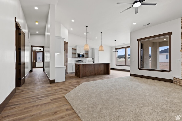 810 E 150 S, Enterprise, UT 84725 - kitchen featuring appliances with stainless steel finishes, open floor plan, ceiling fan, light countertops, and decorative backsplash