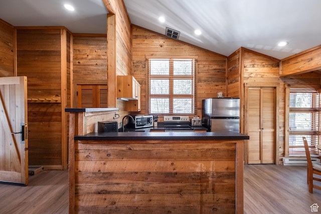 8840 N The Unit 37, Sundance, UT 84604 - kitchen featuring dark countertops, visible vents, appliances with stainless steel finishes, and vaulted ceiling
