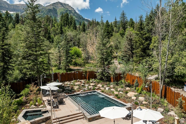 8840 N The Unit 37, Sundance, UT 84604 - view of swimming pool with a mountain view, a jacuzzi, a fenced backyard, and a patio