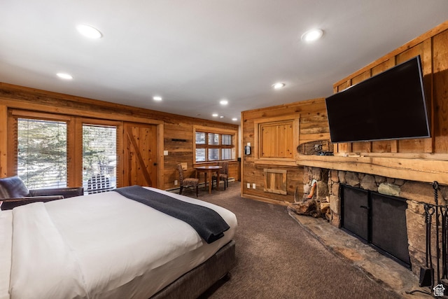 8840 N The Unit 37, Sundance, UT 84604 - bedroom featuring recessed lighting, wooden walls, dark carpet, and a fireplace