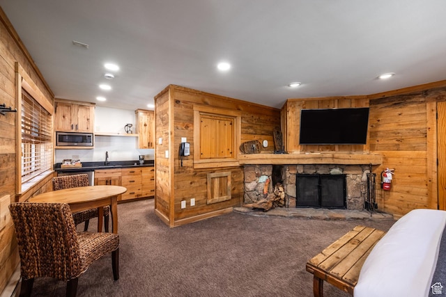 8840 N The Unit 37, Sundance, UT 84604 - living room with wooden walls, recessed lighting, a fireplace, and dark carpet
