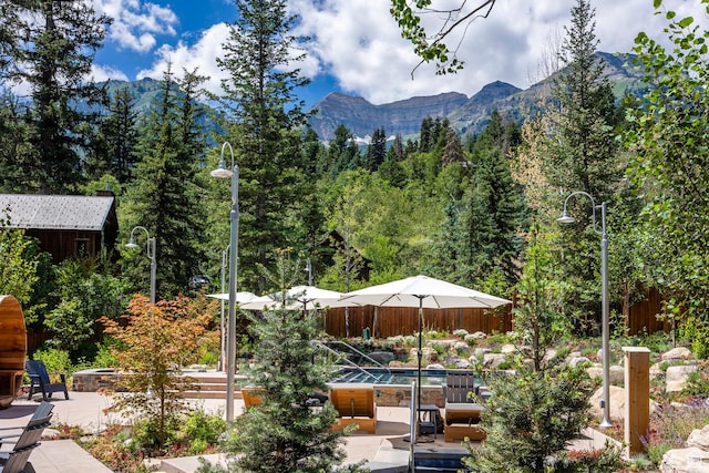 8840 N The Unit 37, Sundance, UT 84604 - view of patio / terrace featuring a fire pit, fence, a shed, an outdoor structure, and a mountain view