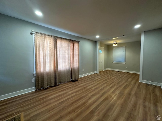 spare room with recessed lighting, wood finished floors, and baseboards