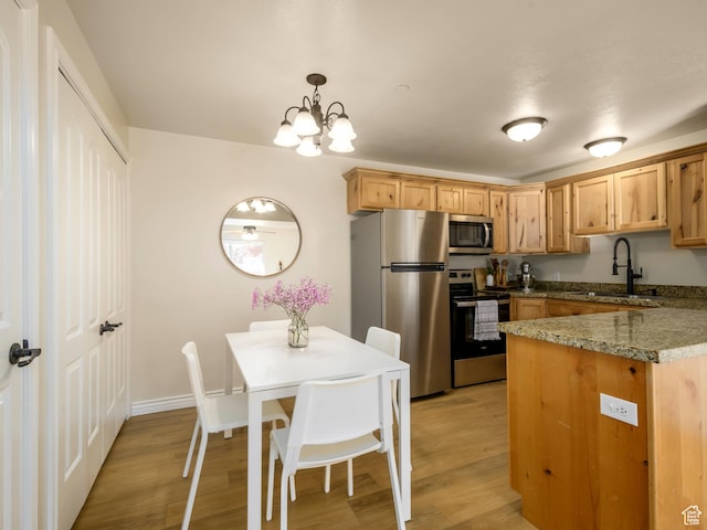 336 S 930 W Unit 203, Pleasant Grove, UT 84062 - kitchen with a chandelier, appliances with stainless steel finishes, light wood-type flooring, and a sink