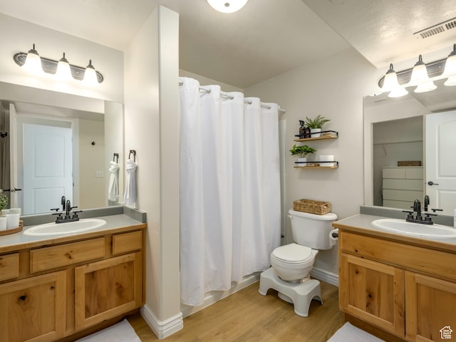 336 S 930 W Unit 203, Pleasant Grove, UT 84062 - bathroom featuring wood finished floors, toilet, two vanities, and a sink