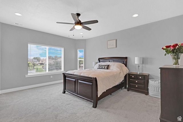 carpeted bedroom featuring baseboards, visible vents, recessed lighting, ceiling fan, and a textured ceiling