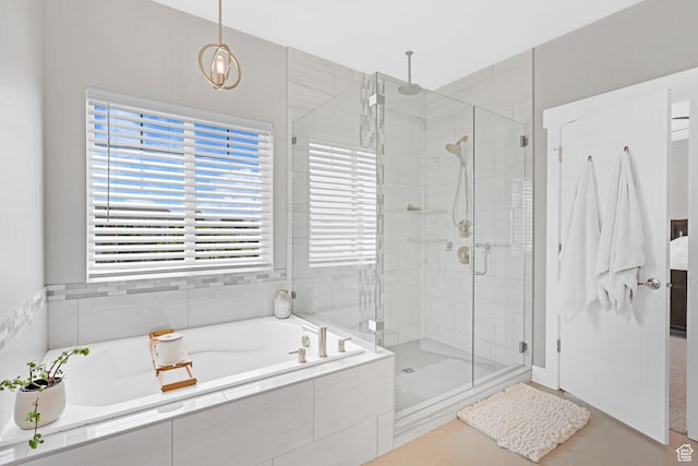 full bathroom featuring tile patterned flooring, a shower stall, and a garden tub