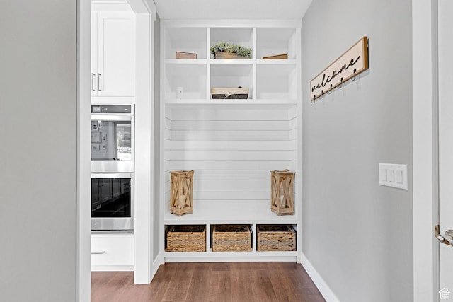mudroom featuring baseboards and wood finished floors