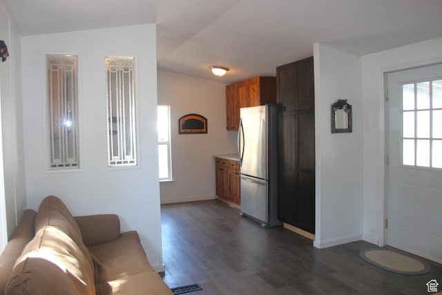 3223 S Nina Loop, Garden City, UT 84028 - interior space featuring visible vents, baseboards, dark wood finished floors, light countertops, and freestanding refrigerator