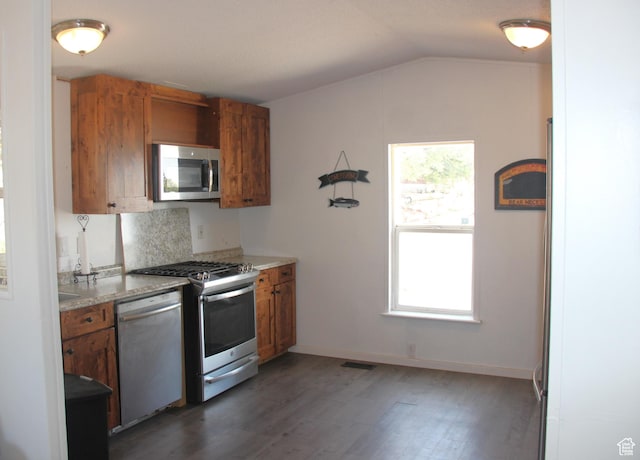 3223 S Nina Loop, Garden City, UT 84028 - kitchen with appliances with stainless steel finishes, brown cabinetry, and vaulted ceiling