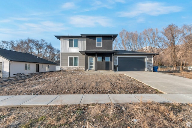 706 W 500 N, Brigham City, UT 84302 - view of front of home with board and batten siding, concrete driveway, and an attached garage