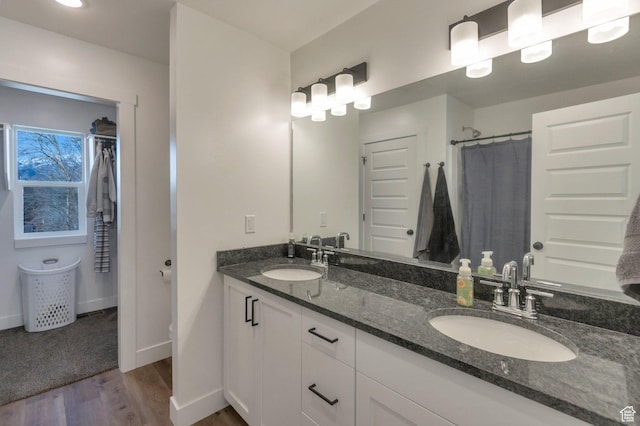 706 W 500 N, Brigham City, UT 84302 - bathroom with a sink, baseboards, wood finished floors, and double vanity