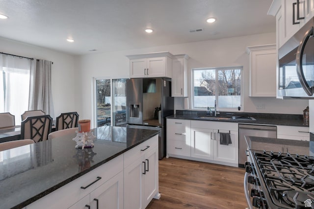 706 W 500 N, Brigham City, UT 84302 - kitchen with visible vents, dark wood finished floors, recessed lighting, stainless steel appliances, and white cabinets