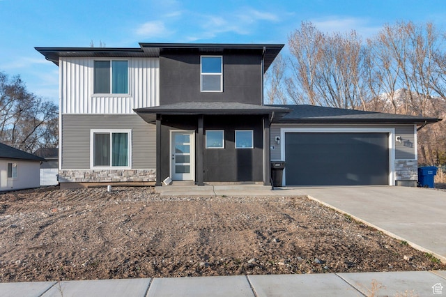 706 W 500 N, Brigham City, UT 84302 - view of front of house featuring a garage, stone siding, and concrete driveway