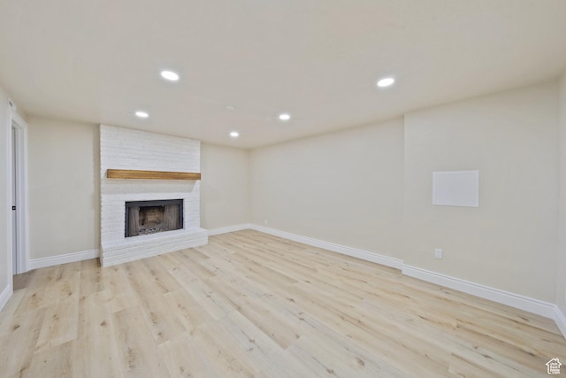 770 S 1680 E, Pleasant Grove, UT 84062 - unfurnished living room featuring recessed lighting, light wood finished floors, a brick fireplace, and baseboards