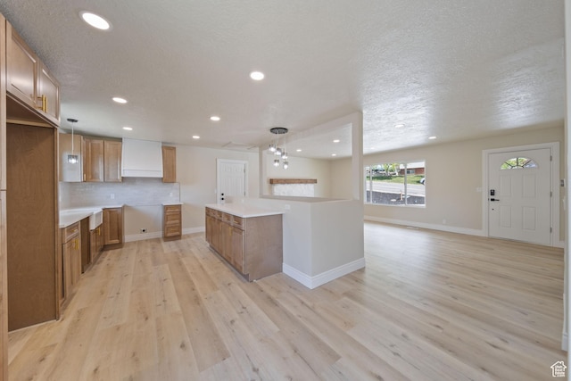 770 S 1680 E, Pleasant Grove, UT 84062 - kitchen featuring a textured ceiling, brown cabinetry, recessed lighting, and light wood-style flooring