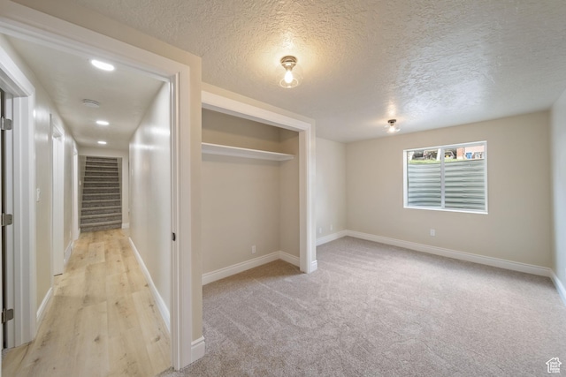 770 S 1680 E, Pleasant Grove, UT 84062 - unfurnished bedroom featuring a textured ceiling, light carpet, baseboards, and a closet