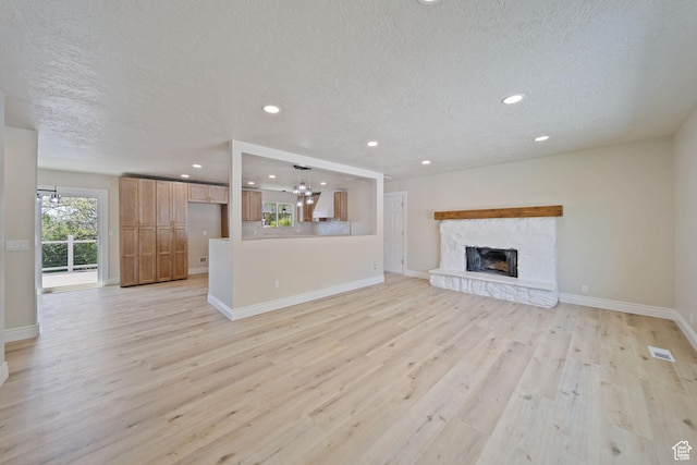 770 S 1680 E, Pleasant Grove, UT 84062 - unfurnished living room with a textured ceiling, a notable chandelier, baseboards, and light wood-type flooring