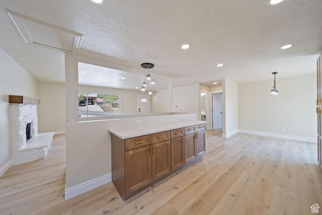 770 S 1680 E, Pleasant Grove, UT 84062 - kitchen with baseboards, brown cabinetry, light wood-style flooring, and a textured ceiling