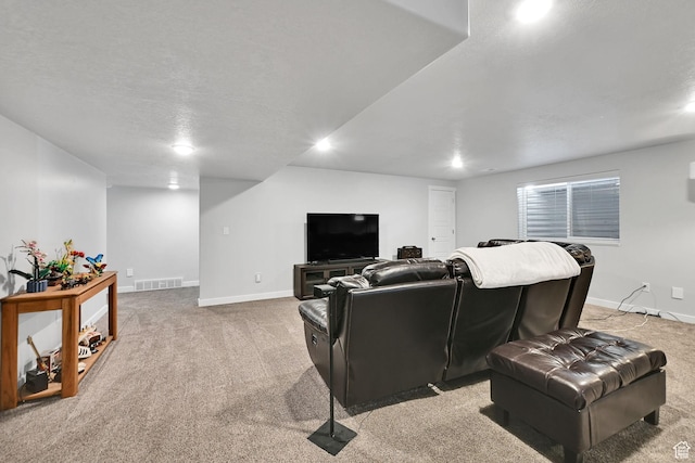 cinema room featuring visible vents, light colored carpet, and baseboards