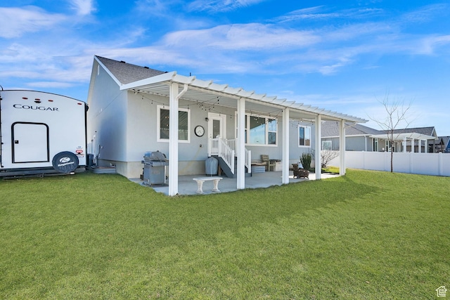 back of property with a patio, fence, and a lawn