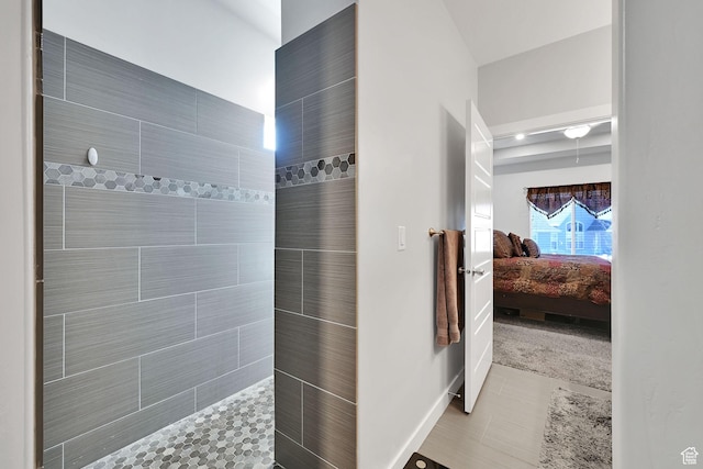 ensuite bathroom featuring tile patterned floors, ensuite bath, and a walk in shower