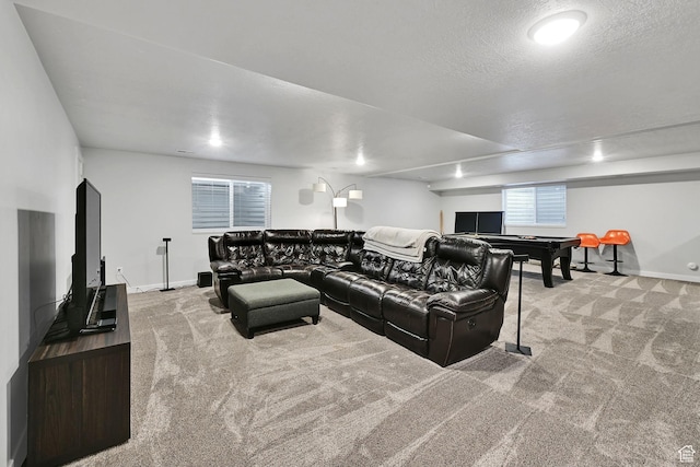 carpeted living area with a textured ceiling and baseboards