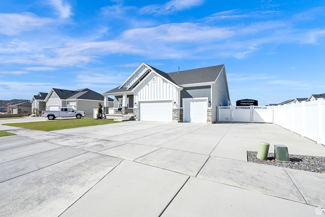 view of property exterior featuring driveway, a gate, fence, board and batten siding, and an attached garage