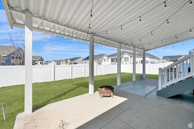 view of patio / terrace with a fenced backyard, a residential view, and an outdoor fire pit