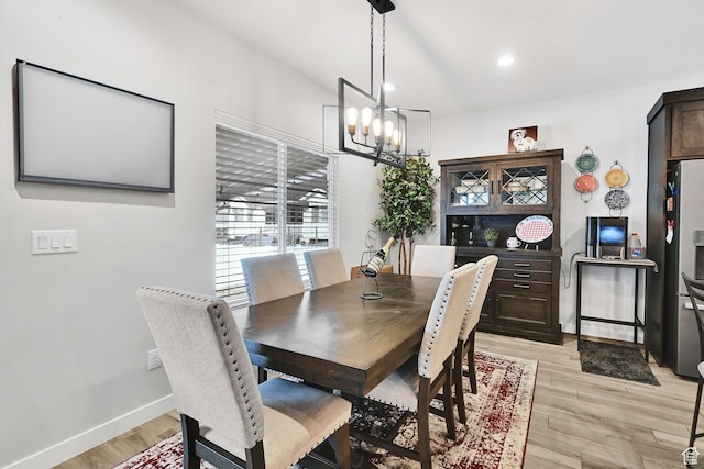 dining area featuring recessed lighting, baseboards, a chandelier, and light wood finished floors