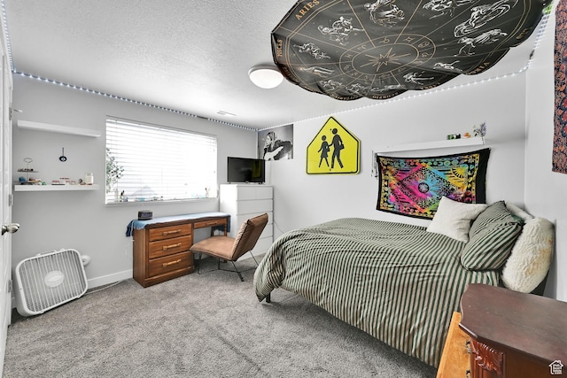 bedroom featuring baseboards, a textured ceiling, and carpet