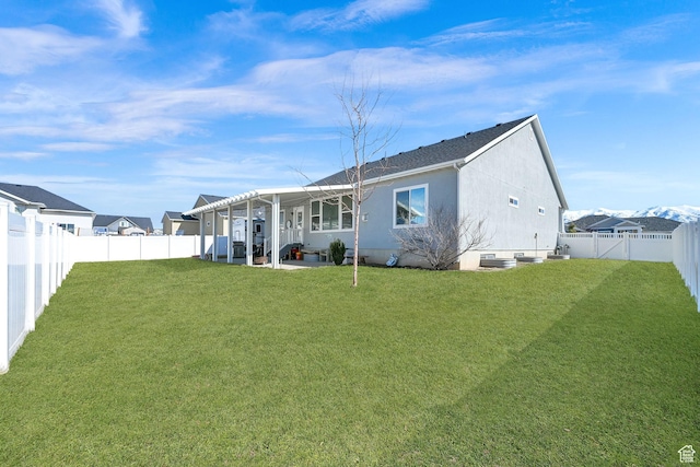 rear view of property featuring stucco siding, a patio, a lawn, and a fenced backyard
