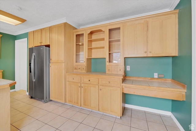 kitchen featuring glass insert cabinets, light brown cabinets, crown molding, and stainless steel fridge with ice dispenser