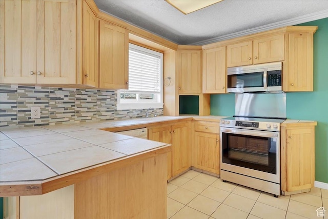 kitchen featuring tile countertops, light brown cabinets, tasteful backsplash, and stainless steel appliances