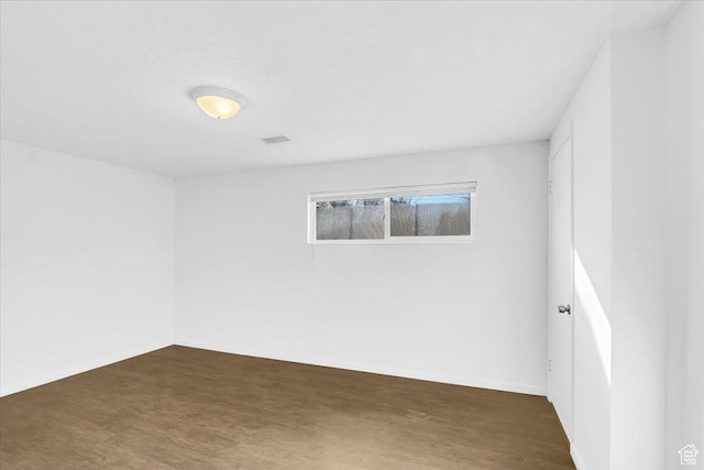 spare room with wood finished floors