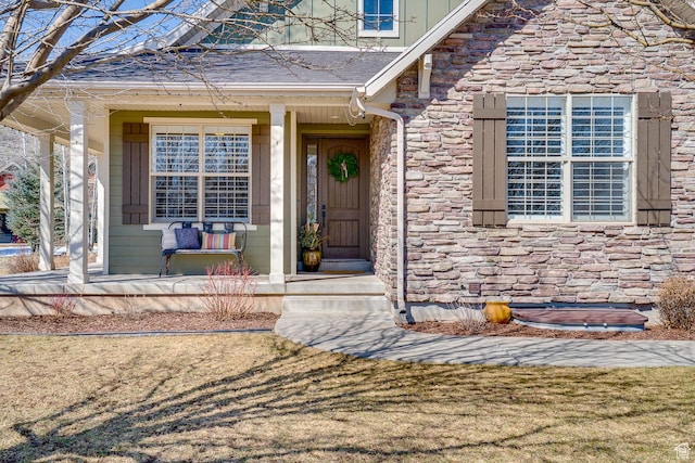 property entrance with stone siding and covered porch