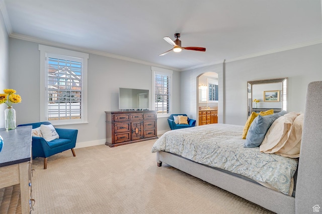 bedroom featuring baseboards, crown molding, carpet floors, ceiling fan, and arched walkways