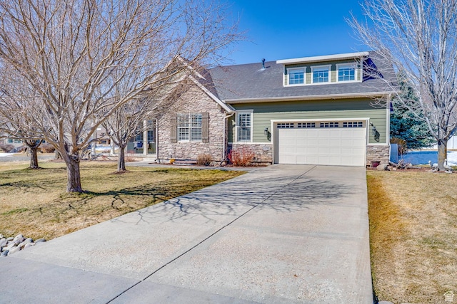 view of front of property with a garage, a front yard, driveway, and stone siding