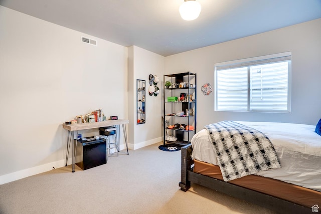 carpeted bedroom with visible vents and baseboards
